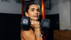 Woman holding dumbbell to represent strength training for women