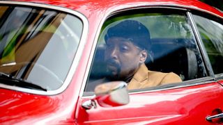 Jesse L. Martin in a red car in The Irrational