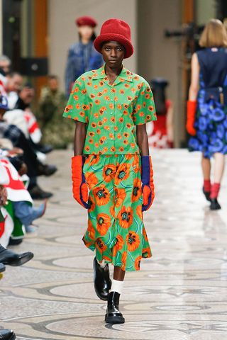 Female model in bright green & orange outfit