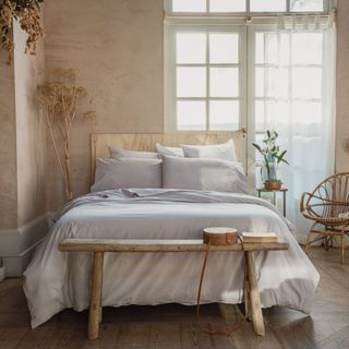 Soft neutral bedroom with off-white double bed