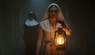 The Nun Valak stalks a young nun in a dark hallway
