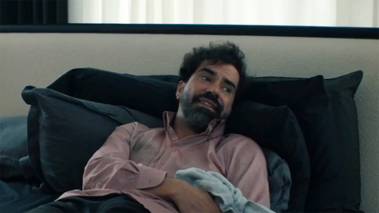 Doug smiling and lying on a bed in Gen V season 2 episode 8