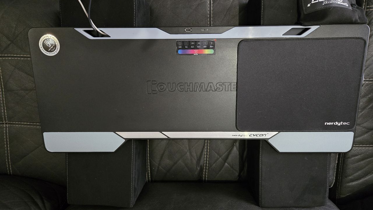 Couchmaster Cycon3 set-up on a sofa with a keyboard and mouse.