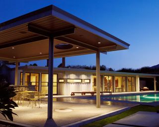 modern pergola with spotlights and nearby pool