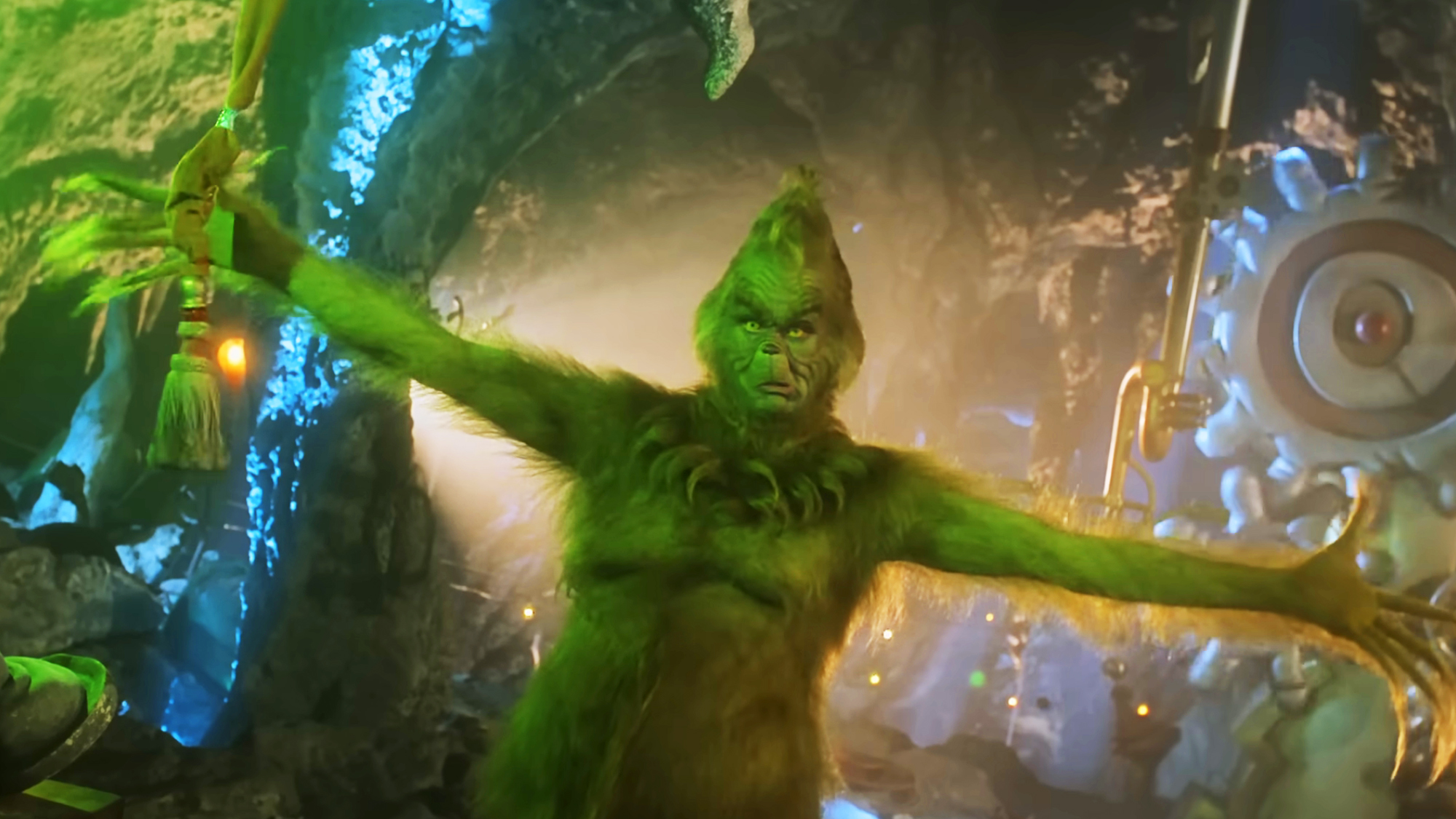 The Grinch, arms opened wide and a scowl on his face, prepares to pull the cord and send Cindy Lou Who back down the mountain chute in How the Grinch Stole Christmas.