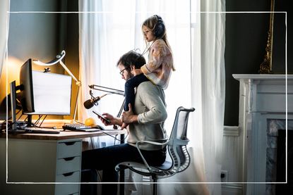 four-day working week illustrated by dad with child sat on his shoulders as he works in the evening