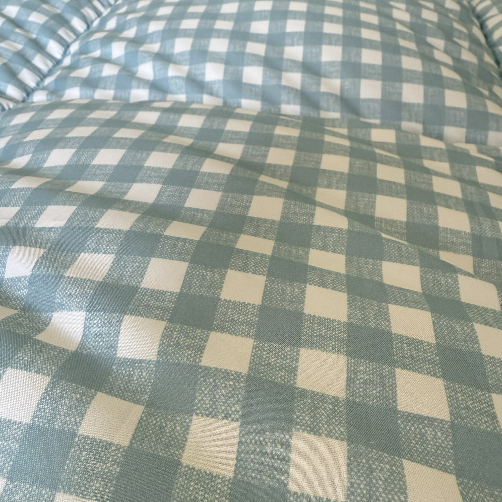The blue gingham Night Lark Coverless Duvet being tested at home
