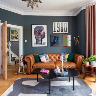 blue living room with leather sofa and artwork
