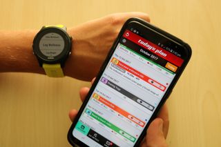 Today's Plan image shows someone shows phone screen with fitness metrics with another hand showing a fitness watch ready to record the data