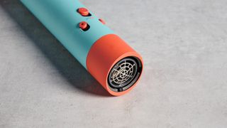 the dyson airwrap ID in teal and terracotta colorway (patina and orange) with a lapis case, with a brush, hairfryer, curling wand attachments