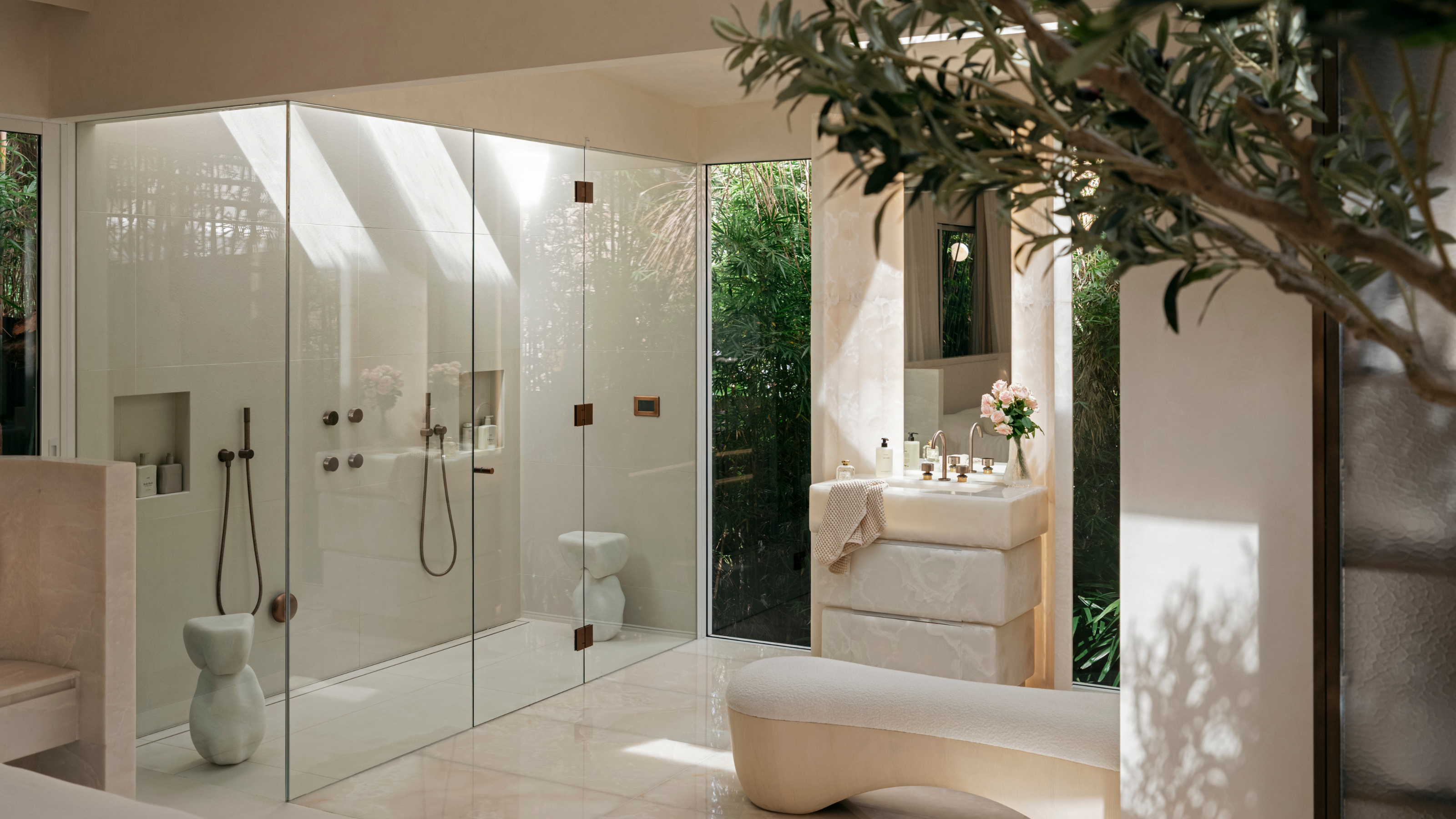 a light filled neutral airy shower bathroom with a double walk in shower 