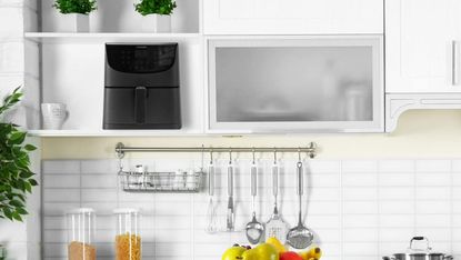 COSORI Air Fryer in white kitchen on shelf