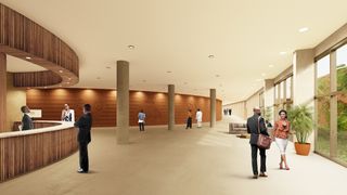 The lobby of the grand assembly hall featuring clear glass floor to celing on the right. on the left is lobby reception desk with vertical wood design detail and someone standing behind the desk. The celing of the lobby area is supported by brown pillars