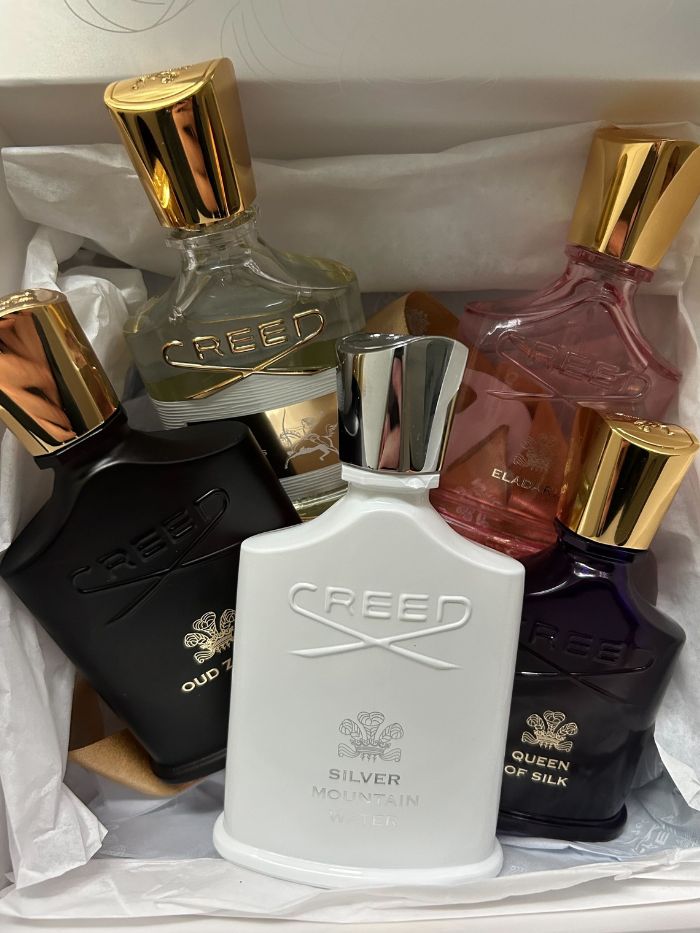 A picture of five Creed perfumes in a white box