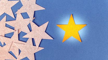 bright gold star next to group of faded gold stars