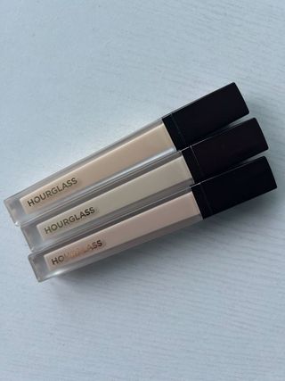 Hourglass concealer packaging on a white table