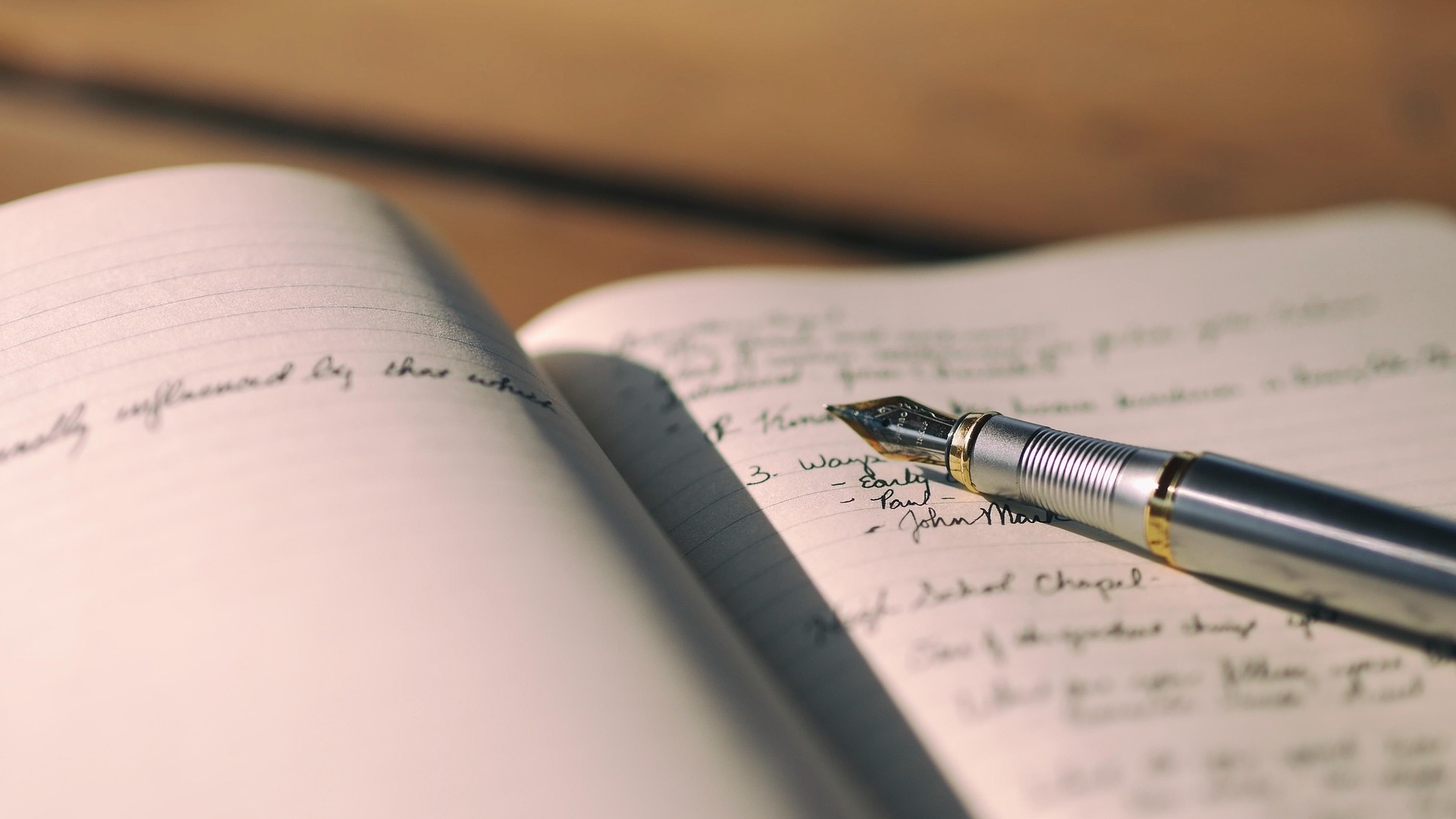 An old-school pen on top of a tablet