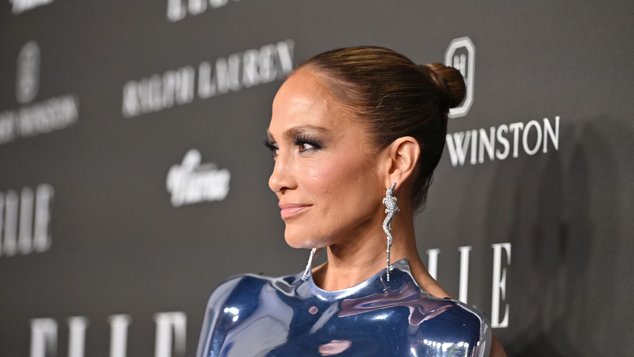 JLo&#039;s slicked-back bun and dangle statement earrings were the perfect combination as the A-lister made a statement on the red carpet