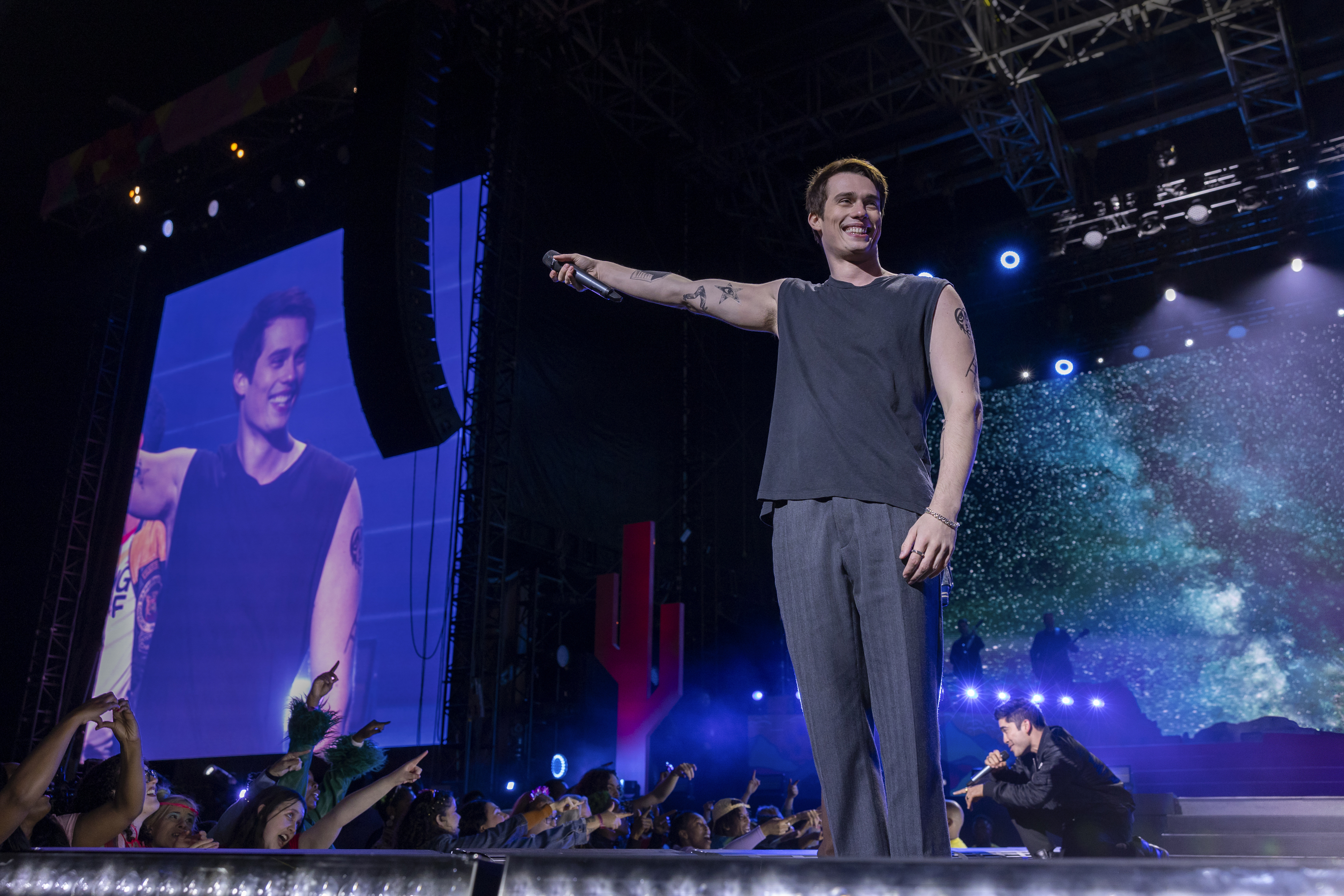 nicholas galitzine stands onstage during a concert in 'the idea of you'