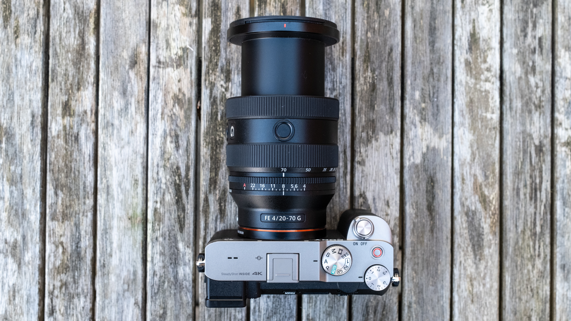 Sony FE 20-70mm F4 G attached to Sony A7C on wooden table lens barrel extended