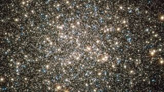 a dense cluster of stars in space