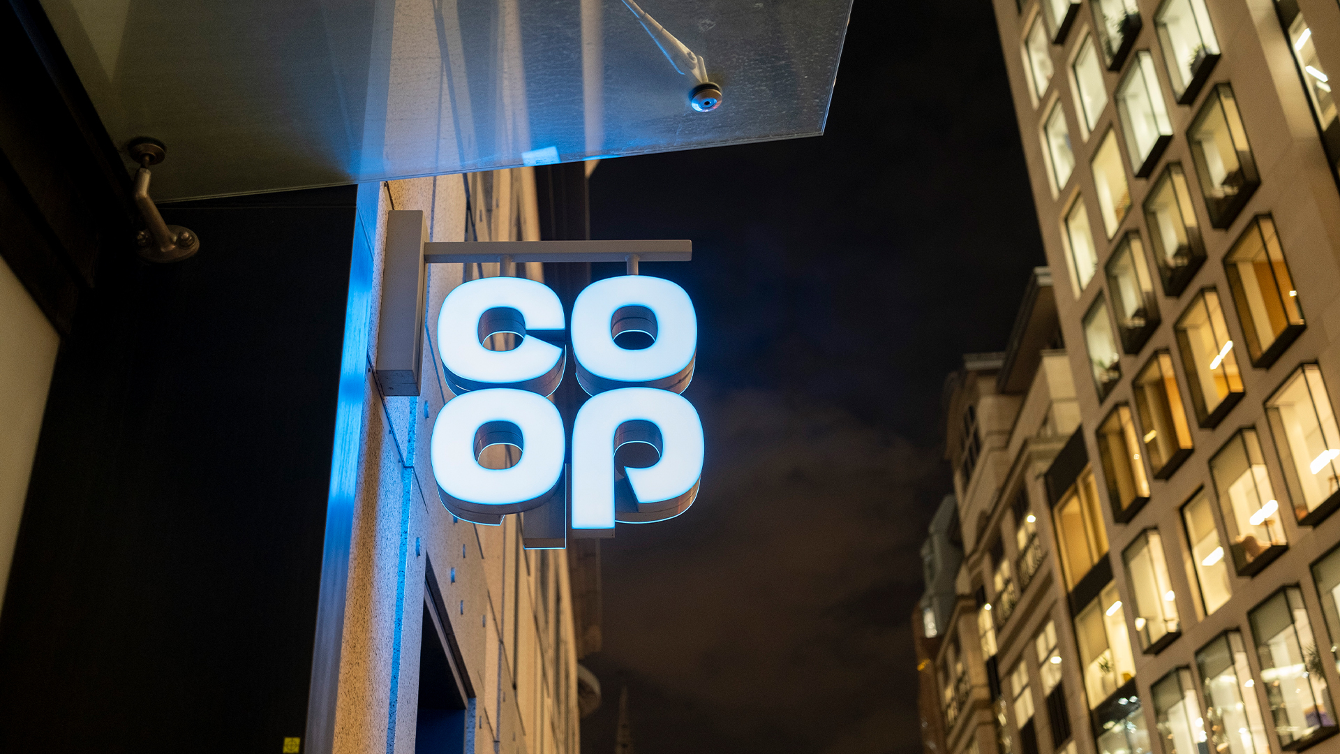 Co-op supermarket sign pictured at night in London, United Kingdom.