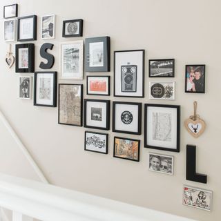 photo frames and wall pieces on white wall