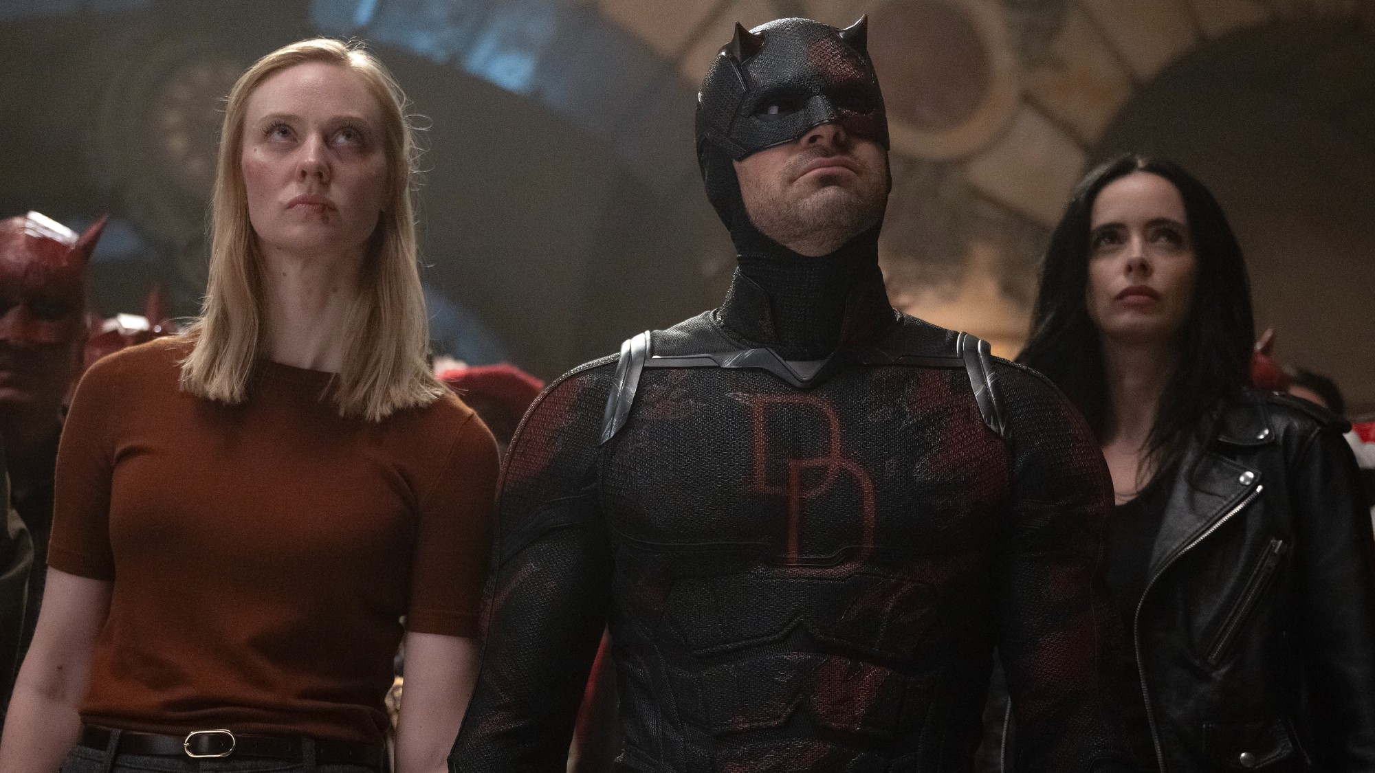 Karen Page (Deborah Ann Woll), Matt Murdock (Charlie Cox) and Jessica Jones (Krysten Ritter) lead protestors on Daredevil: Born Again.
