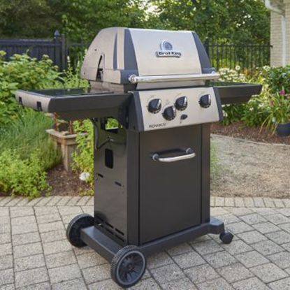Broil King Monarch 320 BBQ in promotional image in garden