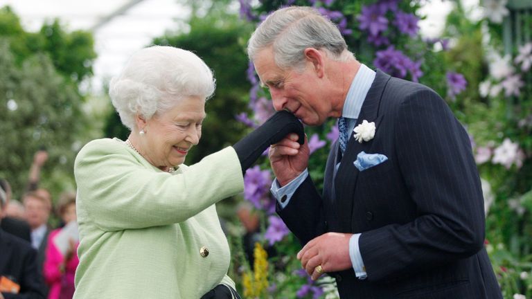 Prince Charles kisses the hand of his mother, Queen Elizabeth. Sang Tan / WPA Pool for Getty Images