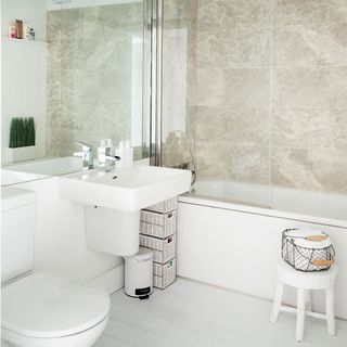 bathroom with whitewashed flooring tap and tiles