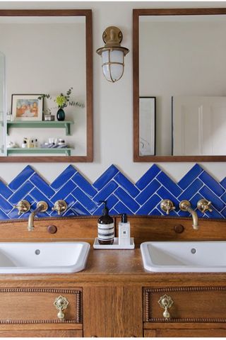 Light filled bathroom with zig zag blue tile backsplash