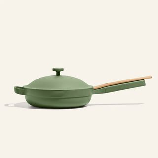 tried and tested gifts: our place always pan in green with wooden spatula balancing on the handle