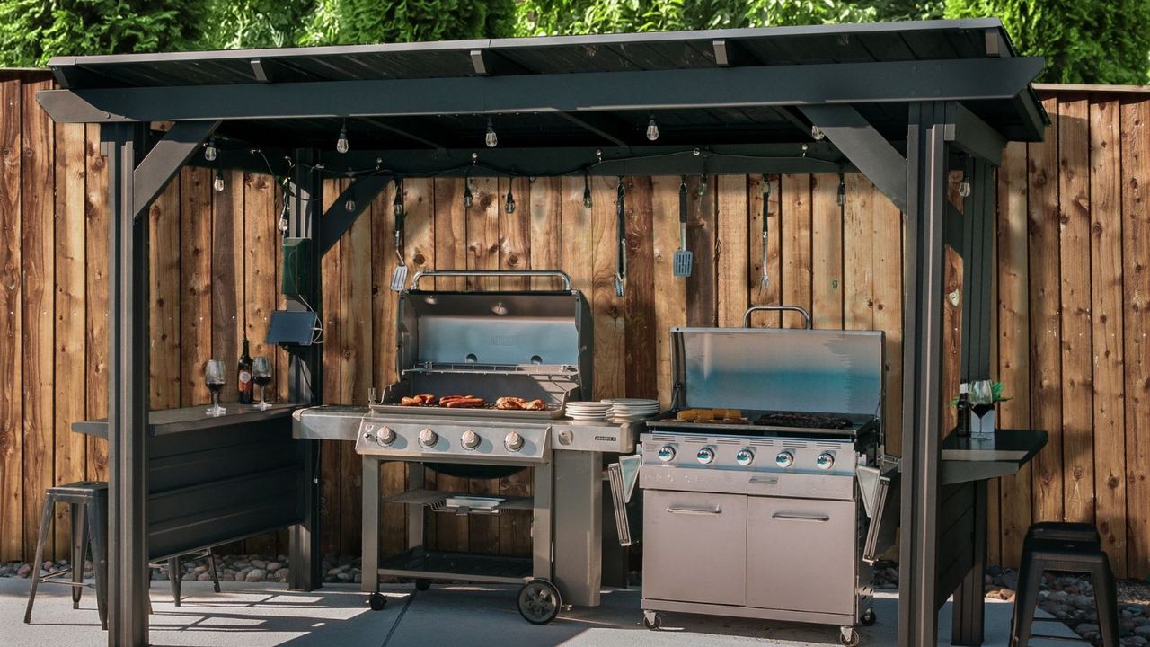 Two gas grills underneath a grill gazebo