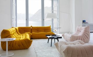 A living room with a few sofa pieces