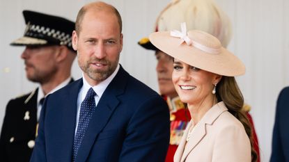 Prince William, Prince of Wales and Catherine, Princess of Wales smile as they stand on the Royal Dais at Datchet Road on July 08, 2025