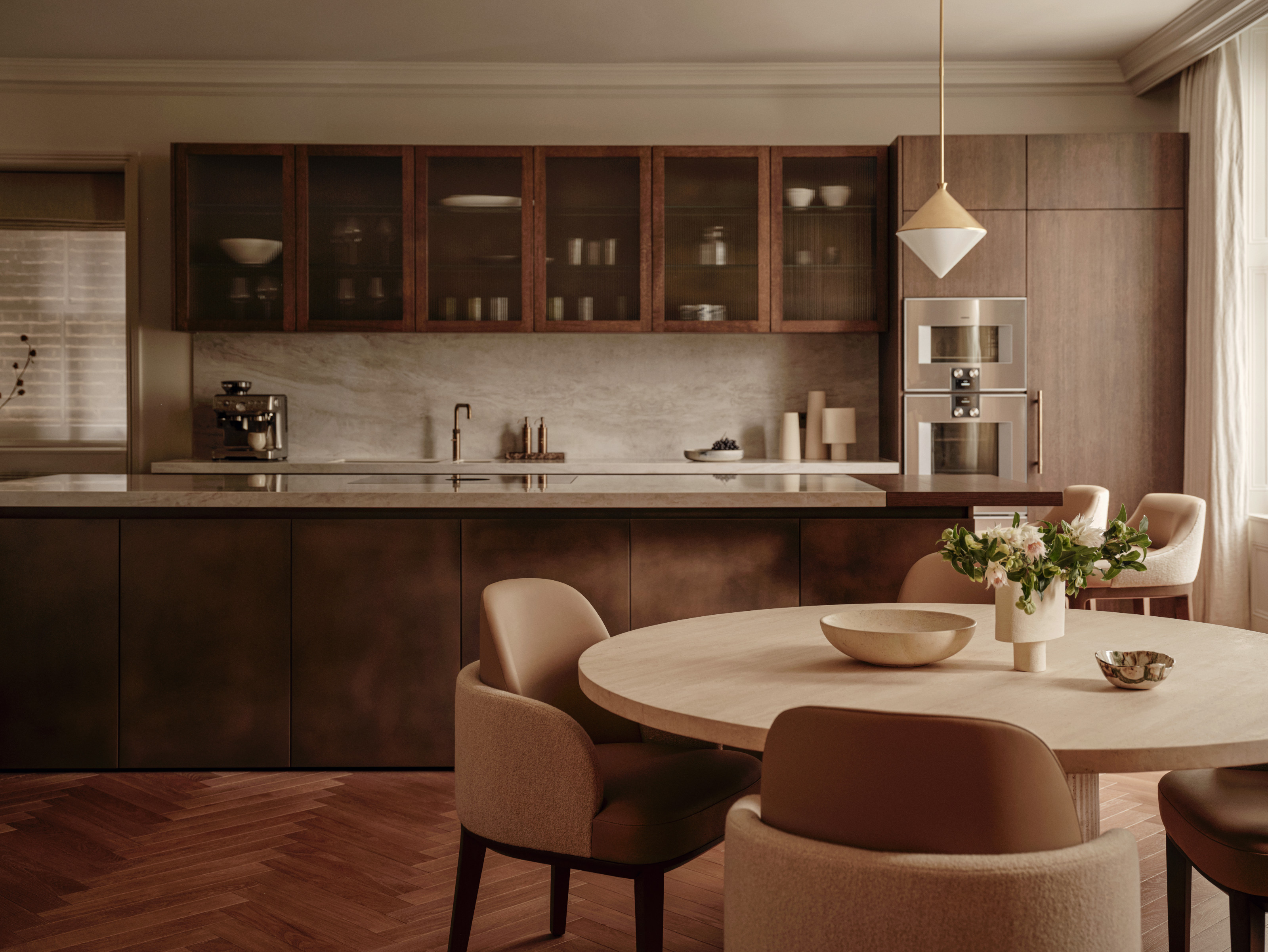 Dark wood kitchen with island and round dining table and chairs