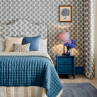 Bedroom with matching wallpaper and headboard fabric