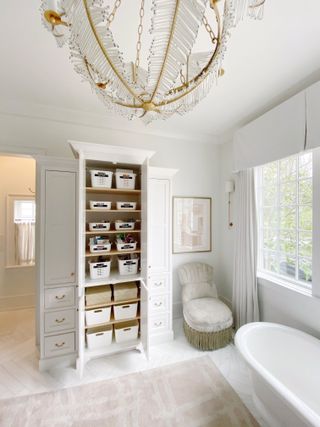 white bathroom with organized cupboards