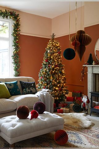 Christmas living room with a copper and navy color scheme and paper decorations