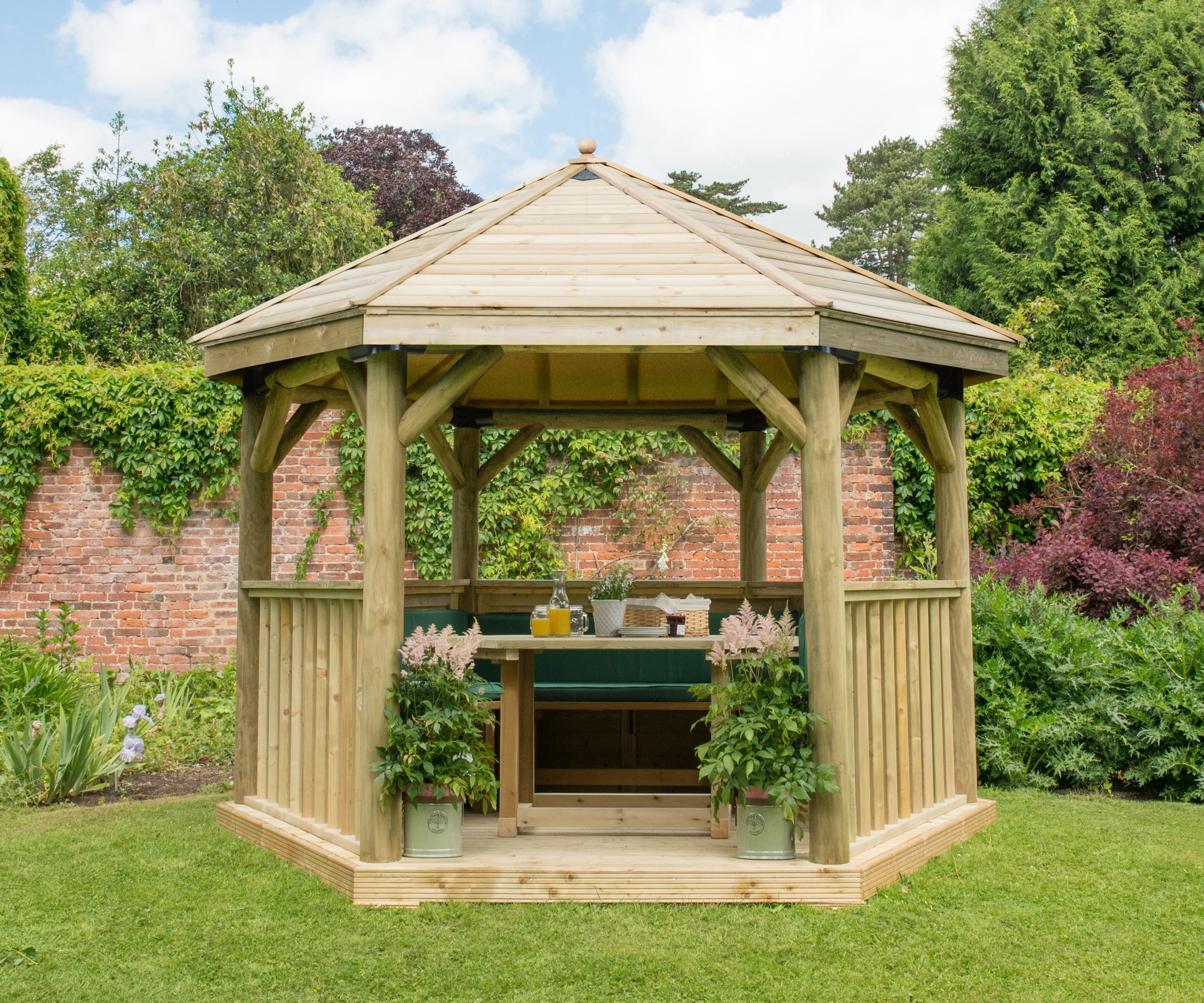 hexagonal timber wooden gazebo on garden lawn with enclose roof and half height sides