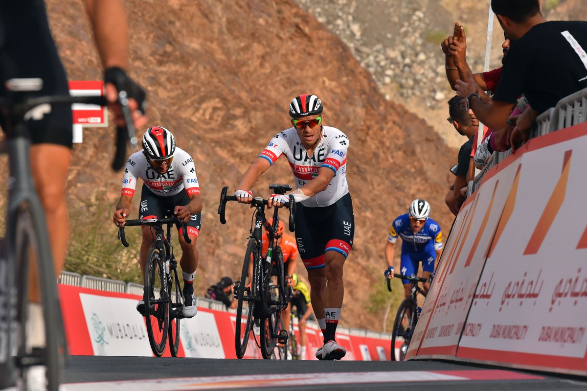Fernando Gaviria looks at Kristoff's bike as they cross the line together