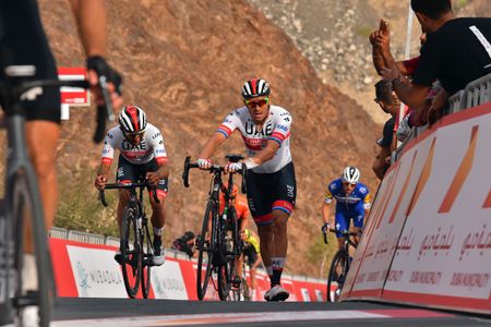 Fernando Gaviria looks at Kristoff's bike as they cross the line together