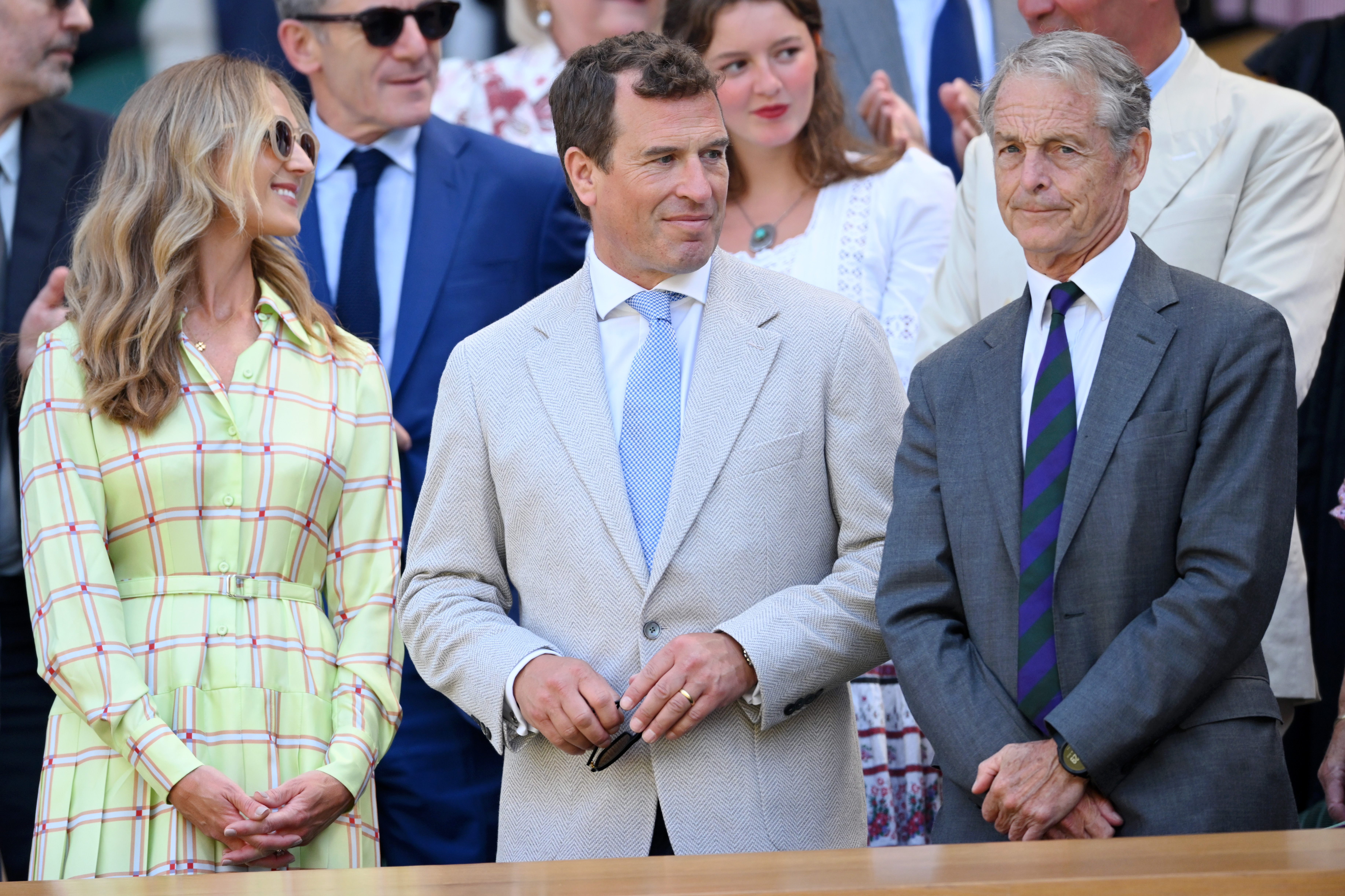 Harriet Sperling and Peter Philips standing up in their seats at Wimbledon