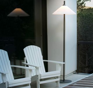 summer house deck with seating and floor lamp