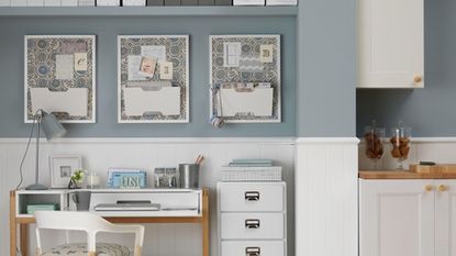 home office with grey and white wall and white desk with white drawer unit