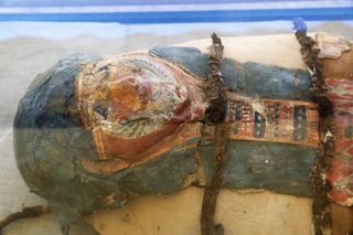 An ancient mummy with a funerary mask.