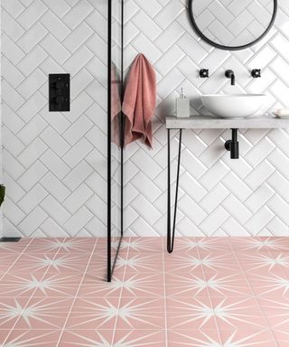 Black and white bathroom with pink lily floor tiles by Walls and Floors