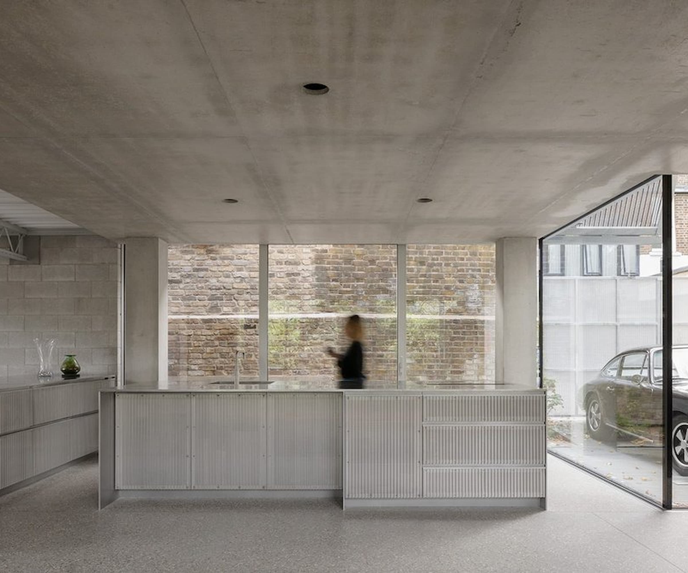 An open plan living room next to a kitchen with a kitchen island