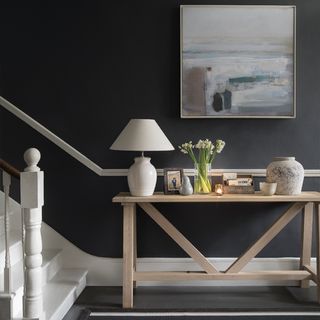 white staircase with grey wall and wooden table